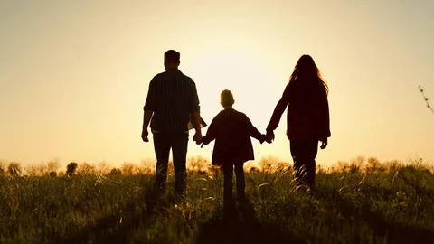 A family silhouette at sunset